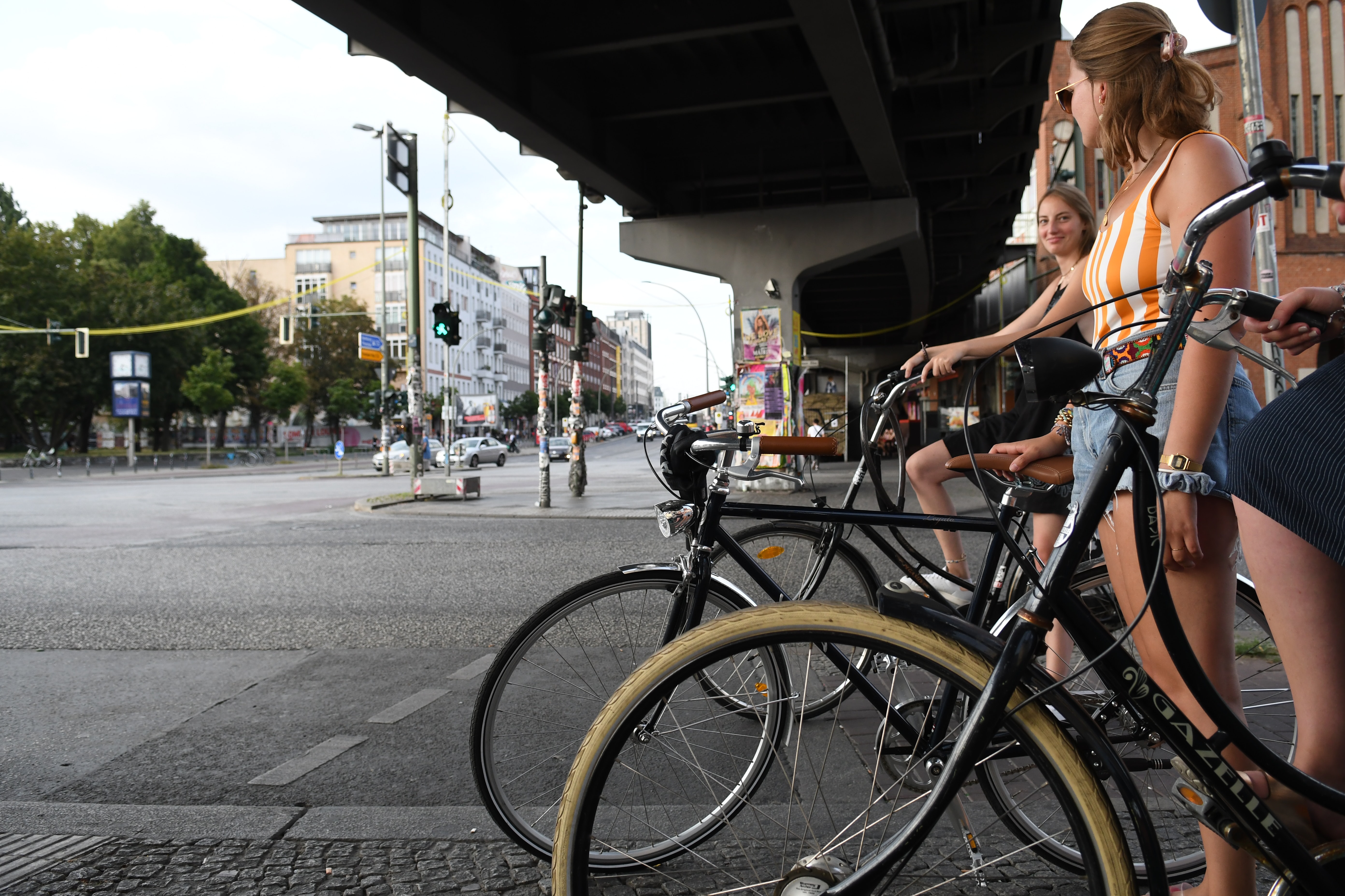 women on bicycles waiting at a road junction