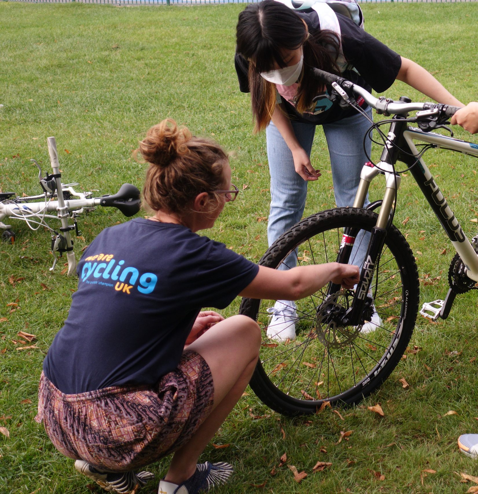 a young lady stood with her electric bicycle