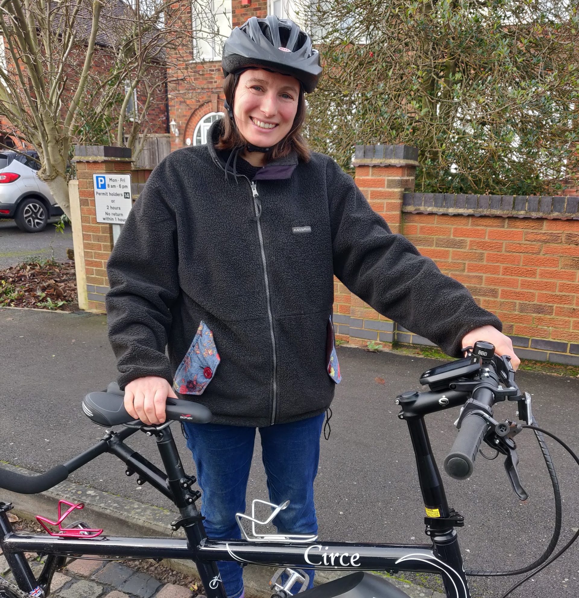 a young lady stood with her electric bicycle